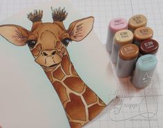 a drawing of a giraffe next to some crayons