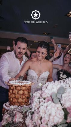 a bride and groom cutting their wedding cake