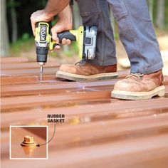 a man is using a drill to fix a wooden floor with a screwdriver