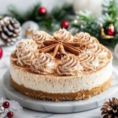 a cheesecake on a white plate surrounded by christmas decorations