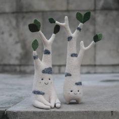 two stuffed animals sitting on top of cement