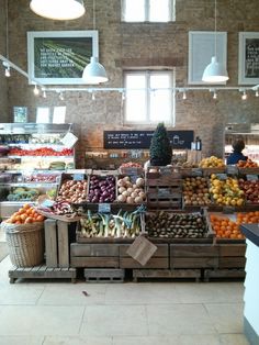 an open market with fruits and vegetables on display