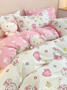 a hello kitty bed set with pink and white polka dots on the comforter, pillows and pillowcases