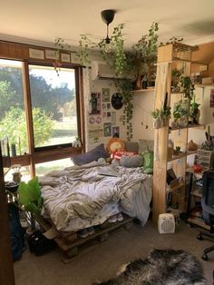 a bed room with a neatly made bed and lots of plants on the wall next to it