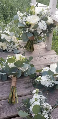 flowers and greenery are arranged on the steps