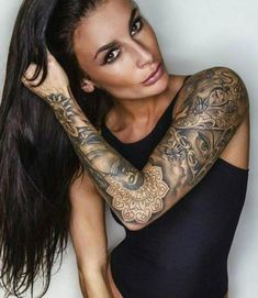 a woman with tattoos on her arms and arm