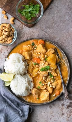 a plate with rice, chicken and cashews on it