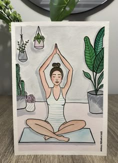 a card with a drawing of a woman doing yoga in front of potted plants