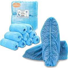 a pile of blue baby blankets sitting on top of a white floor next to a bag