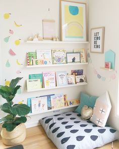 a child's room with bookshelves and toys on the shelves above it