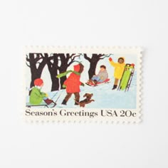 a stamp with people on skis and snowboards in the background is an image of trees