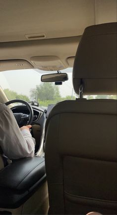 a man sitting in the driver's seat of a car