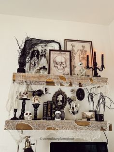 a mantle with candles, pictures and other decorations on it in a living room area