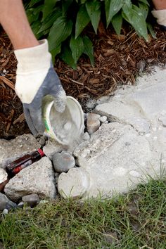 a man is pouring cement onto the ground