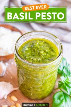 basil pesto in a jar on a cutting board