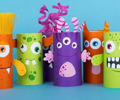 some toilet paper rolls with different colored monsters on them