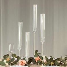 candles and flowers are arranged on a table