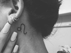 a woman with a tattoo on her neck and behind her ear that reads i love you