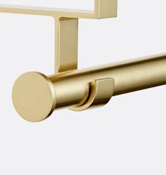 an image of a gold shower handle on a white wall