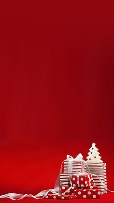 a red background with presents wrapped in white and polka dots on the bottom right corner