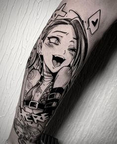 a woman's arm with an anime character tattoo on it