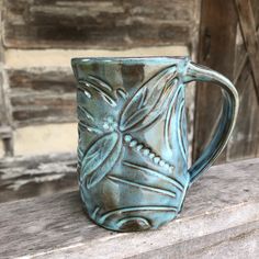 a coffee mug sitting on top of a wooden table