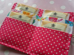 the pink and white polka dot fabric is folded into two sections with zippers on each side