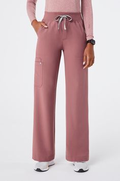 Why We Love ThisGo wide with on-the-pulse appeal. The High Waisted Isabel Wide Leg Scrub Pants features a roomy silhouette with eight pockets and a super comfy waistband.

Model Fit Description
Model is 511.5' / Wearing XS Tall

Petite length: 29', for heights up to 55'
Regular length: 31', for heights 56' - 58'
Tall length: 33', for heights 59' and above
Total of eight pockets
Two front slash pockets
One interior security pocket
One clean finish pocket peeking out from the patch pocket
One pen pocket in interior of the clean finish pocket
One mitered patch pocket on the side seam
Two back pockets on the yoke
High rise
Wide leg fit
Yoga waistband with adjustable drawcord
Clean hem
Engineered with Technical Comfort™
All of our scrubs are named after places weve donated scrubs and people wev Figs Scrubs Outfit Joggers, Comfy Scrubs, Figs Pink Scrubs, Fig Scrubs Women, Pink Nursing Scrubs, Purple Figs Scrubs, Dark Harbor, Leg Scrub, Figs Scrubs