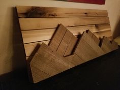 a piece of wood sitting on top of a table next to a wall mounted painting