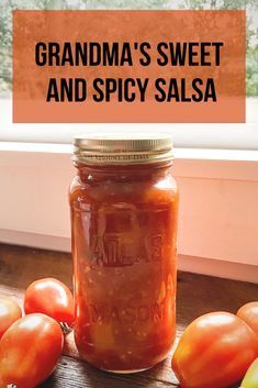 a jar filled with tomato sauce sitting on top of a wooden table next to tomatoes