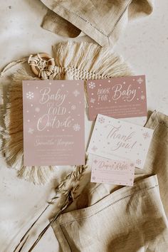 two pink and white baby shower cards on top of a blanket