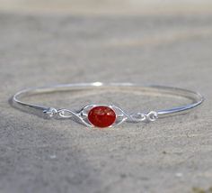 Celtic style bracelet in sterling silver or 9ct yellow, white or rose gold.Cremation ashes in Enigma Crystal Ruby, Sapphire, Emerald, Amethyst, Turquoise or Rose Quartz in 8mm by 6mm oval setting.Ruby shown, please see the colours page on my website for further options https://enigmahorsehairjewellery.co.uk/cremation-ash-jewelleryGold is hallmarked. Ashes Jewelry Cremation, Oval Setting, 7 Jewelry, Memorial Bracelet, Celtic Style, Ashes Jewelry, Cremation Ashes, Cremation Jewelry, Keepsake Jewelry