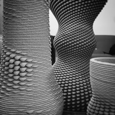 three large vases are stacked on top of each other in this black and white photo