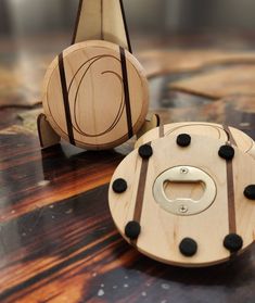 two wooden toys sitting on top of a table next to each other with holes in them