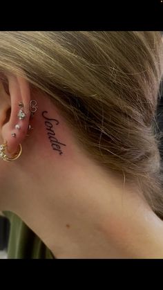 a woman's ear with the word love written on it