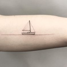 a black and white photo of a small sailboat on the arm, done in ink