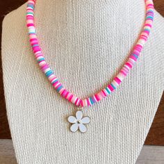 This cute FLOWER Charm necklace can make any outfit more special! Little girls will love the bright heishi beads in pink and turquoise and cute flower charm! This stretchy necklace fits right over your head so it's easy to put on- no clasps needed. Our custom jewelry is made to order so all sales are final. The necklace is beautifully packaged and ready to gift. Receipts are never included. If you want to include a special note, please let me know in the comments. Please be advised small parts c Cute Flower Beaded Necklaces With Colorful Beads, Cute Flower-shaped Colorful Beaded Necklaces, Cute Pink Flower Shaped Necklace, Cute Pink Flower-shaped Necklace, Fun Pink Necklace For Birthday, Pink Adjustable Necklace For Birthday, Sweet Pink Jewelry With Colorful Beads, Playful Pink Beaded Necklaces For Birthdays, Pink Letter Beads Fun Necklaces