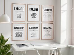 four black and white posters on the wall above a desk