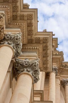 the top part of an ornate building with columns