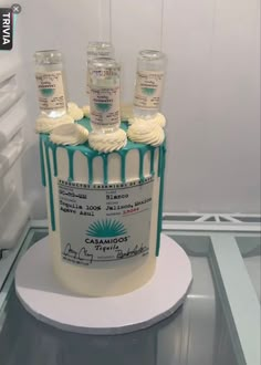 a cake decorated with icing and frosting on top of a refrigerator freezer