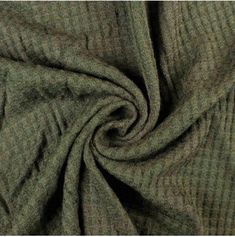 a close up view of a green fabric textured with fine lines and stripes on an unbuttoned background