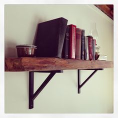 a shelf with books and cups on it