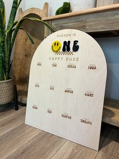 a wooden calendar with a smiley face on it