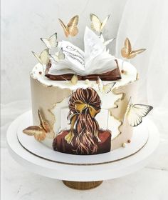 there is a cake decorated with butterflies and a woman's face on the side