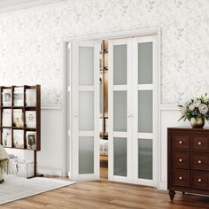 a bedroom with white walls and wooden floors