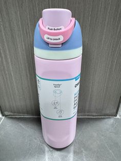 a pink and blue cup sitting on top of a counter