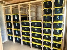 the storage room is filled with black and yellow bins