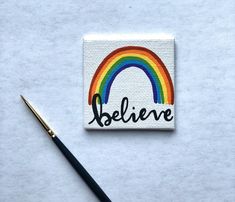 a small patch with the word believe painted on it and a paintbrush next to it