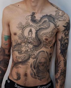 a shirtless man with tattoos on his chest