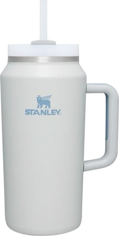 the stanley coffee mug is white and has a blue logo on it, along with a straw in its mouth